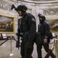 Members of the U.S. Secret Service Counter Assault Team walk through the Rotunda as they and other federal police forces responded as violent protesters loyal to President Donald Trump stormed the U.S. Capitol in Washington, Jan. 6, 2021. Top congressional Democrats are demanding that the Department of Homeland Security’s inspector general hand over information on deleted Secret Service text messages related to the Jan. 6, 2012 attack on the Capitol, accusing him of using delay tactics to stonewall their investigation. (AP Photo/J. Scott Applewhite, File)