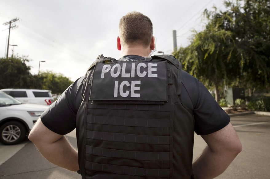 A U.S. Immigration and Customs Enforcement (ICE) officer looks on during an operation in Escondido, Calif., July 8, 2019. (AP Photo/Gregory Bull) **FILE**
