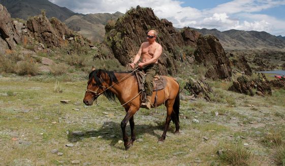 FILE - Then Russian Prime Minister Vladimir Putin rides a horse while traveling in the mountains of the Siberian Tyva region (also referred to as Tuva), Russia, Aug. 3, 2009. Putin has shot back at Western leaders who mocked his athletic exploits, saying they would look þÄúdisgustingþÄù if they tried to emulate his bare-torso appearances. Putin made the comment during a visit to Turkmenistan early Thursday, June 30, 2022 when asked about Western leaders joking about him at the G-7 summit. (Alexei Druzhinin/Pool Photo via AP, file)