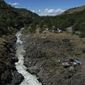 Water rushes through Lyle Falls in the Klickitat River, a tributary that runs into the Columbia River, on Sunday, June 19, 2022, in Lyle, Wash. For generations, Indigenous people have fished for salmon and trout from scaffolds perched just above the sacred water. (AP Photo/Jessie Wardarski)