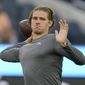 Los Angeles Chargers quarterback Justin Herbert (10) warms up before an NFL football game against the Los Angeles Rams Sunday, Aug. 14, 2022, in Inglewood, Calif. (AP Photo/Ashley Landis)