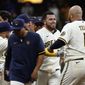 Milwaukee Brewers&#x27; Victor Caratini, second from right, is congratulated by teammates after his two-run single during the 11th inning of the team&#x27;s baseball game against the Los Angeles Dodgers on Tuesday, Aug. 16, 2022, in Milwaukee. The Brewers won 5-4. (AP Photo/Aaron Gash)