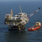 A rig and supply vessel are pictured in the Gulf of Mexico, off the coast of Louisiana on April 10, 2011. (AP Photo/Gerald Herbert, File)