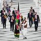 Kimia Yousofi, front left, and Farzad Mansouri, of Afghanistan, carry their country&#39;s flag during the opening ceremony in the Olympic Stadium at the 2020 Summer Olympics on July 23, 2021, in Tokyo, Japan. Afghanistan&#39;s flag bearer at the Tokyo 2020 Games and other prominent women&#39;s sports campaigners have been safely relocated to Australia following a year-long Australian Olympic Committee (AOC) project. (AP Photo/David J. Phillip, File) **FILE**