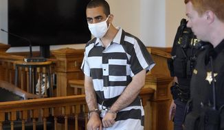 Hadi Matar, 24, center, arrives for an arraignment in the Chautauqua County Courthouse in Mayville, NY., Saturday, Aug. 13, 2022. Matar, the man charged with stabbing Salman Rushdie on a lecture stage in western New York on Friday, Aug. 12 said in an interview that he was surprised to learn the accomplished author had survived the attack. (AP Photo/Gene J. Puskar, File)