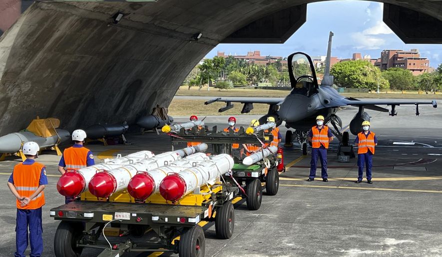 Military personnel stand next to Harpoon A-84, anti-ship missiles and AIM-120 and AIM-9 air-to-air missiles prepared for a weapon loading drills in front of a F16V fighter jet at the Hualien Airbase in Taiwan&#x27;s southeastern Hualien county on Wednesday, Aug. 17, 2022. Taiwan is staging military exercises to show its ability to resist Chinese pressure to accept Beijing&#x27;s political control over the island. (AP Photo/Johnson Lai)