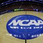In this March 21, 2013, file photo, taken with a fisheye lens, the NCAA logo is displayed on the court during the NCAA college basketball tournament in Philadelphia. NCAA officials sent a letter to its membership Thursday, AUg. 18, 2022, noting its enforcement&#39;s staff pursuit of “potential violations” of the name, image and likeness compensation policy and emphasizing the need for schools to help investigations. (AP Photo/Matt Slocum, File) **FILE**
