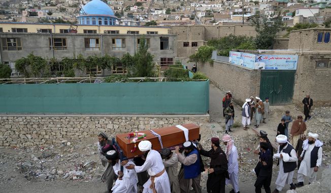 Mourners carry the body of a victim of a mosque bombing in Kabul, Afghanistan, Thursday, Aug. 18. 2022. A bombing at a mosque in Kabul during evening prayers on Wednesday killed at least 10 people, including a prominent cleric, and wounded over two dozen, an eyewitness and police said. (AP Photo/Ebrahim Noroozi)