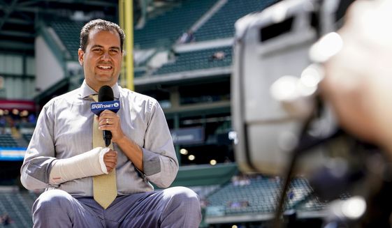 Los Angeles Dodgers television reporter David Vassegh works on a pregame broadcast before a baseball game against the Milwaukee Brewers Thursday, Aug. 18, 2022, in Milwaukee. Vassegh said he broke two bones in his right wrist and cracked six ribs Wednesday when he tumbled and crashed into the padding at the end of his slide down &amp;quot;Bernie&#39;s Chalet,&amp;quot; where Brewers mascot Bernie Brewer takes up residence behind the American Family Field left-field stands. (AP Photo/Morry Gash)