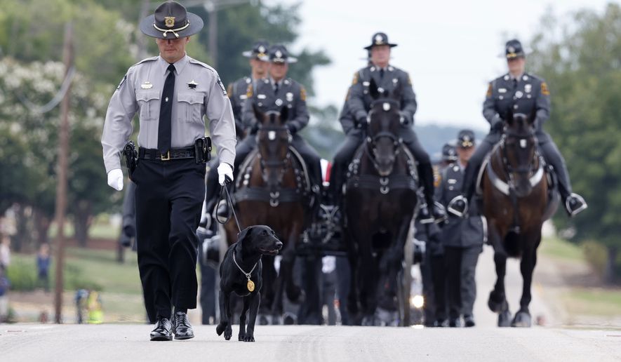 Slain Wake County Sheriff&#39;s Deputy Ned Byrd&#39;s K-9 partner, Sasha, leads the N.C. State Highway Patrol&#39;s Caisson Unit during a procession for Deputy Byrd before his funeral at Providence Baptist Church in Raleigh, N.C., Friday, Aug. 19, 2022. Byrd, 48, had been with the sheriff&#39;s office for 13 years. Byrd was responding to a domestic call and was killed after stopping along a dark stretch of road late at night. (Ethan Hyman/The News &amp; Observer via AP)