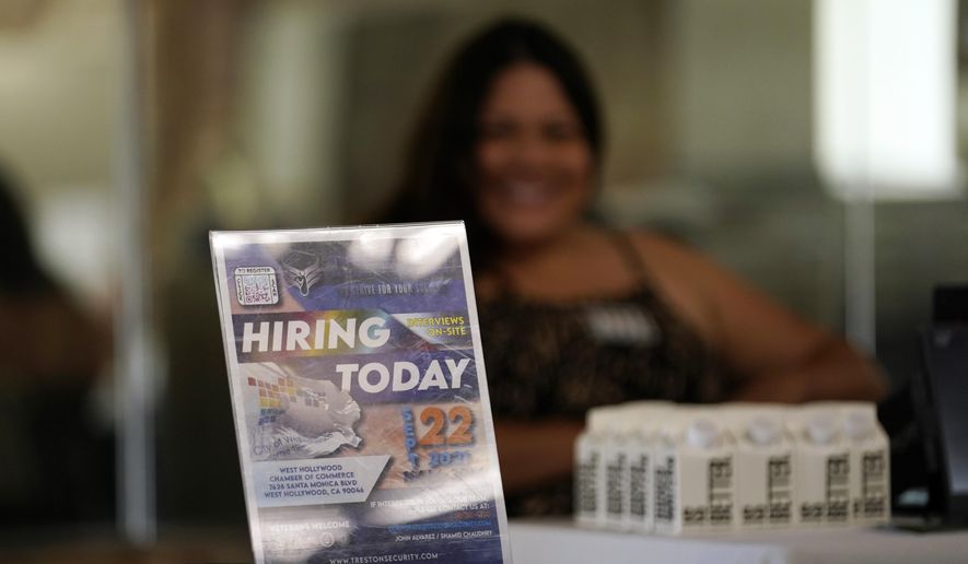 A hiring sign is placed at a booth for prospective employers during a job fair Wednesday, Sept. 22, 2021, in the West Hollywood section of Los Angeles. (AP Photo/Marcio Jose Sanchez, File)