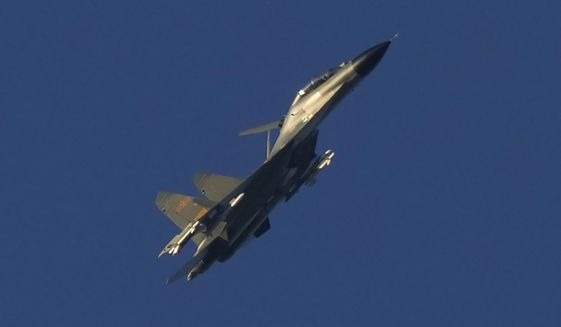 A Chinese J-11 military fighter jet flies above the Taiwan Strait near Pingtan, the closest land of mainland China to the island of Taiwan, in southeastern China&#39;s Fujian Province, Friday, Aug. 5, 2022. Experts say a lot can be gleaned from what China has done, and not done, in the large-scale military exercises it held in response to U.S. House Speaker Nancy Pelosi&#39;s visit to Taiwan, followed by Taiwan&#39;s own drills and Beijing announcing more maneuvers planned. (AP Photo/Ng Han Guan, File)