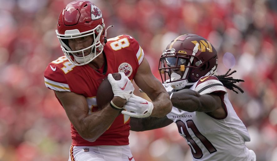 Kansas City Chiefs wide receiver Justin Watson, left, catches a pass as Washington Commanders safety Kamren Curl (31) defends during the first half of an NFL preseason football game Saturday, Aug. 20, 2022, in Kansas City, Mo. (AP Photo/Charlie Riedel)