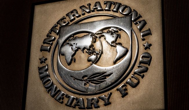 The logo of the International Monetary Fund is visible on their building, April 5, 2021, in Washington. The IMF is facing pressure to eliminate, or at least, reevaluate how it imposes fees on loans it disperses to needy countries like war-torn Ukraine — which is one of the fund&#x27;s biggest borrowers. (AP Photo/Andrew Harnik)