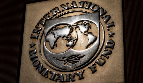 The logo of the International Monetary Fund is visible on their building, April 5, 2021, in Washington. The IMF is facing pressure to eliminate, or at least, reevaluate how it imposes fees on loans it disperses to needy countries like war-torn Ukraine — which is one of the fund&#39;s biggest borrowers. (AP Photo/Andrew Harnik)