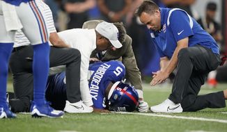 Trainers check on New York Giants defensive end Kayvon Thibodeaux (5) after he was injured during the first half of a preseason NFL football game against the Cincinnati Bengals Sunday, Aug. 21, 2022, in East Rutherford, N.J. (AP Photo/John Minchillo) **FILE**