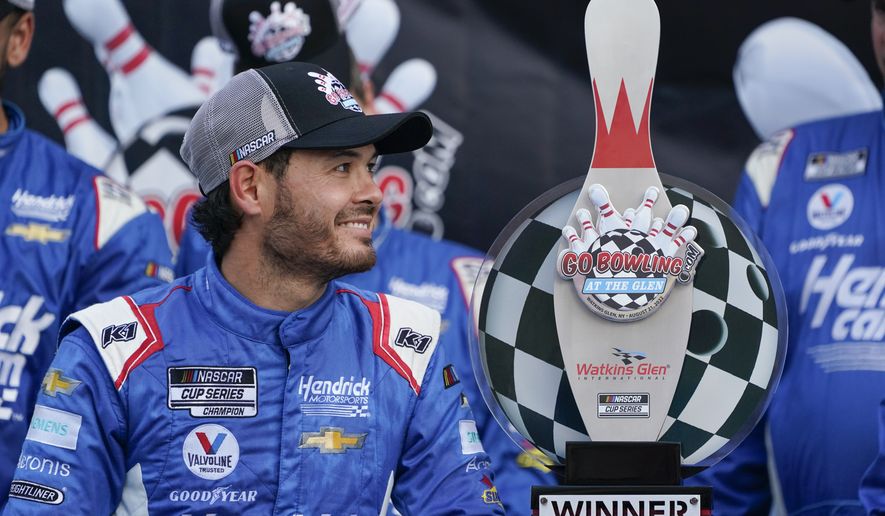 Kyle Larson looks at his trophy after winning a NASCAR Cup Series auto race in Watkins Glen, N.Y., Sunday, Aug. 21, 2022. (AP Photo/Seth Wenig)