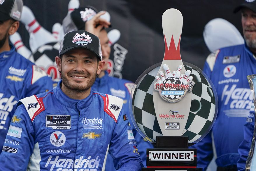 Kyle Larson smiles with his trophy after winning a NASCAR Cup Series auto race in Watkins Glen, N.Y., Sunday, Aug. 21, 2022. (AP Photo/Seth Wenig) **FILE**