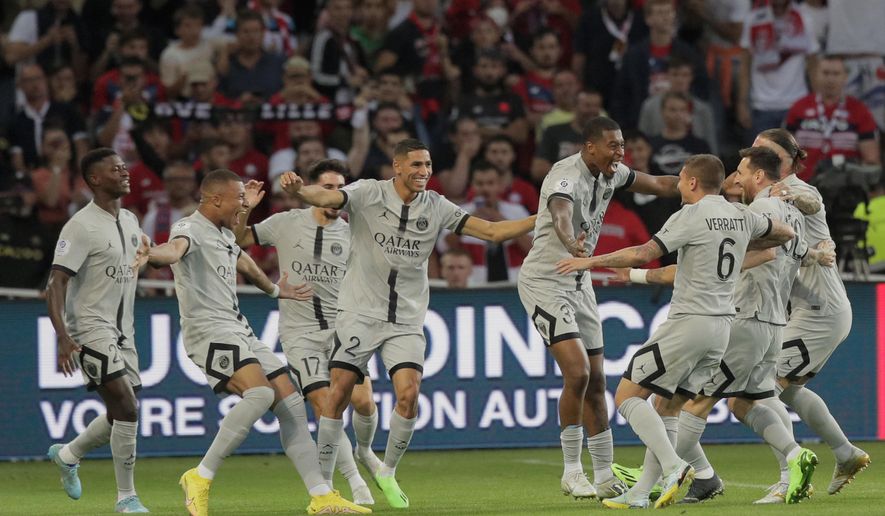 PSG&#39;s Kylian Mbappe, second left, celebrates with teammates after scoring his side first goal during the French League One soccer match between Lille and Paris Saint Germain at the Pierre Mauroy stadium in Villeneuve d&#39;Ascq, northern France, Sunday, Aug. 21, 2022. (AP Photo/Michel Spingler)