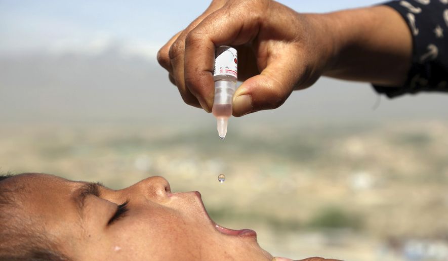 An Afghan health worker uses an oral polio vaccine on a child as part of a campaign to eliminate polio, on the outskirts of Kabul, Afghanistan, April 18, 2017. For years, global health officials have used billions of drops of an oral vaccine in a remarkably effective campaign aimed at wiping out polio in its last remaining strongholds — typically, poor, politically unstable corners of the world. Now, in a surprising twist in the decades-long effort to eradicate the virus, authorities in Jerusalem, New York and London have discovered evidence that polio is spreading there. The source of the virus? The oral vaccine itself.  (AP Photo/Rahmat Gul, File)
