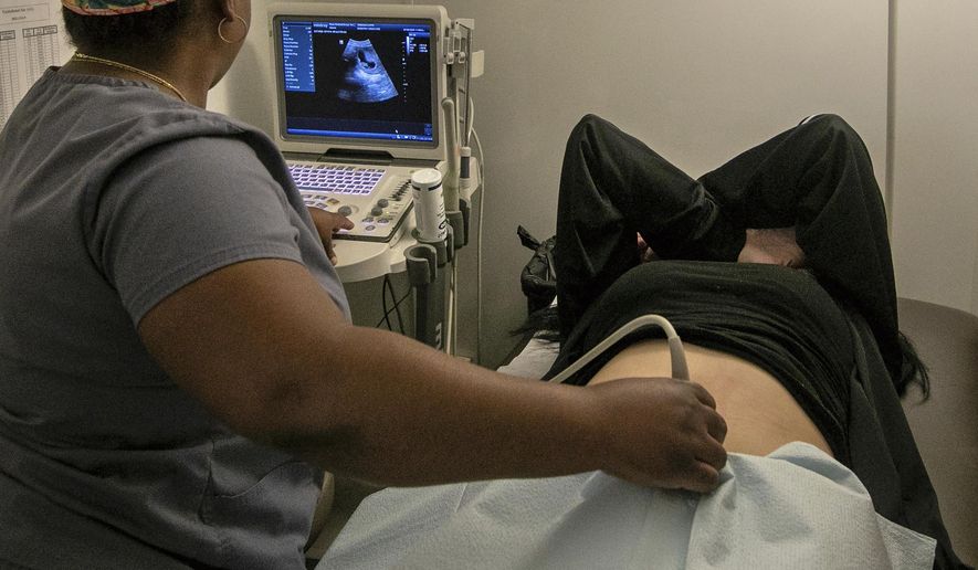 An operating room technician performs an ultrasound on a patient at an abortion clinic in Shreveport, La., Wednesday, July 6, 2022. Serious pregnancy complications are rare in the United States but they still affect thousands of women each year. (AP Photo/Ted Jackson, File)