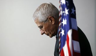 FILE - Dr. Anthony Fauci, director of the National Institute of Allergy and Infectious Diseases, listens as President Donald Trump speaks during a coronavirus task force briefing at the White House, April 4, 2020, in Washington. Fauci, the nation&#x27;s top infectious disease expert who became a household name, and the subject of partisan attacks, during the COVID-19 pandemic, announced Monday he will depart the federal government in December after more than 5 decades of service.  (AP Photo/Patrick Semansky)