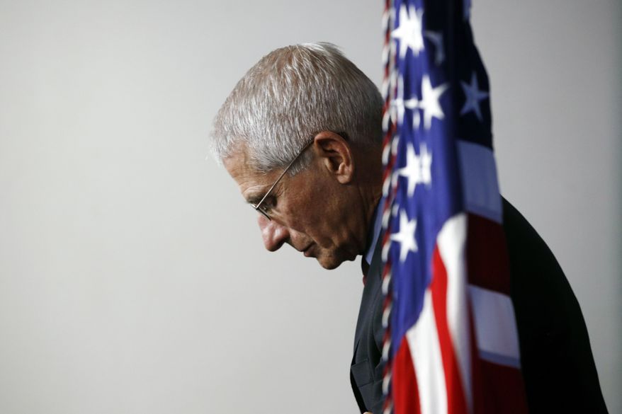FILE - Dr. Anthony Fauci, director of the National Institute of Allergy and Infectious Diseases, listens as President Donald Trump speaks during a coronavirus task force briefing at the White House, April 4, 2020, in Washington. Fauci, the nation's top infectious disease expert who became a household name, and the subject of partisan attacks, during the COVID-19 pandemic, announced Monday he will depart the federal government in December after more than 5 decades of service. (AP Photo/Patrick Semansky)