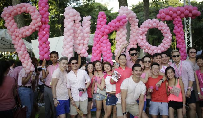 Thousands of people gathered at a park for the annual Pink Dot gay pride event on Saturday, July 1, 2017, in Singapore. Singapore announced Sunday, Aug. 21, 2022, it will decriminalize sex between men by repealing a colonial-era law while protecting the city-state&#x27;s traditional norms and its definition of marriage. (AP Photo/Wong Maye-E, File)