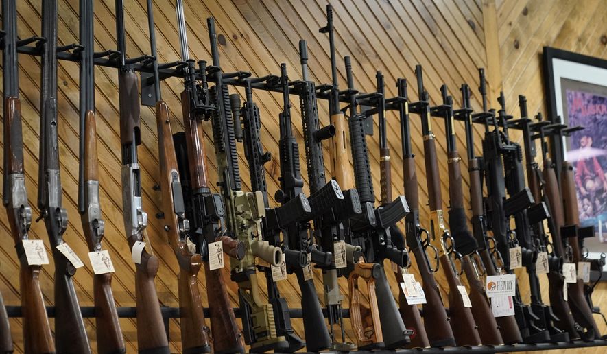 Various guns are displayed at a store on July 18, 2022, in Auburn, Maine. Most U.S. adults think gun violence is increasing nationwide and want to see gun laws made stricter. That's according to a new poll that finds broad public support for a variety of gun restrictions. The poll comes from the University of Chicago Harris School of Public Policy and The Associated Press-NORC Center for Public Affairs Research. (AP Photo/Robert F. Bukaty, File)