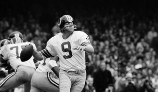FILE - Washington quarterback Sonny Jurgensen looks to pass against the Giants during an NFL football game in 1974. The Washington Commanders will retire Pro Football Hall of Famer Sonny Jurgensen’s No. 9 later this season. The former Washington quarterback and longtime radio broadcaster will be honored in the team&#x27;s regular-season finale Jan. 7 or 8 against the rival Dallas Cowboys. (AP Photo/File)