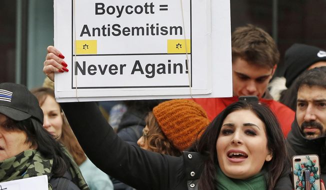 Nationally known far-right activist Laura Loomer holds up a sign across the street from a rally organized by Women&#x27;s March NYC, Jan. 19, 2019, after she barged onto the stage interrupting Women&#x27;s March NYC director Agunda Okeyo who was speaking during a rally in New York. Loomer, who&#x27;s been banned by several social media platforms because of anti-Muslim and other remarks, is challenging incumbent Republican Dan Webster, who has served central Florida districts since 2011. (AP Photo/Kathy Willens) **FILE**