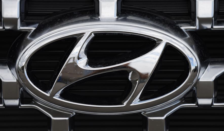 The Hyundai company logo is displayed Sunday, Sept. 12, 2021, in Littleton, Colo. Hyundai and Kia are telling owners, Tuesday, Aug. 23, 2022,  of some large SUVs to park them outdoors and away from structures after a series of fires involving trailer hitch wiring. The Korean automakers are recalling more than 281,000 vehicles in the U.S. because of the problem, but they haven’t figured out how to fix it yet. (AP Photo/David Zalubowski, File)