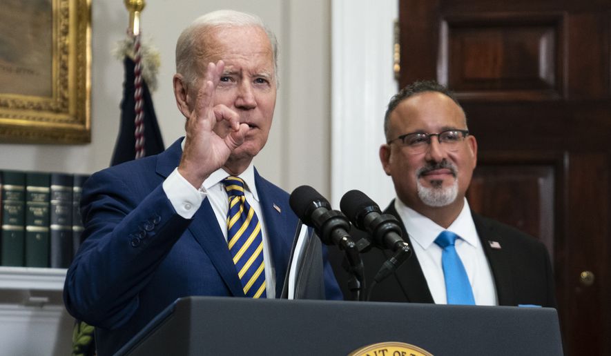 President Joe Biden responds to a question about the FBI search of former President Donald Trump&#39;s Mar-a-Lago estate Wednesday, Aug. 24, 2022, in the Roosevelt Room of the White House in Washington. Education Secretary Miguel Cardona listens at right. (AP Photo/Evan Vucci)