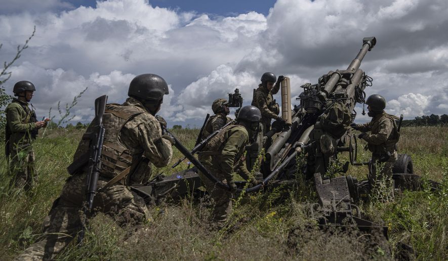 Ukrainian servicemen prepare to fire at Russian positions from a U.S.-supplied M777 howitzer in Kharkiv region, Ukraine, July 14, 2022. Supplies of Western weapons, including U.S. HIMARS multiple rocket launchers, has significantly boosted the Ukrainian military&#x27;s capability, allowing it to target Russian munitions deports, bridges and other key facilities with precision and impunity. (AP Photo/Evgeniy Maloletka, File)