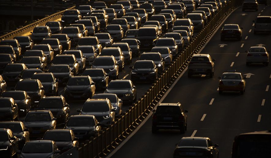 Rush hour traffic backs up along a highway in Beijing, China, on April 23, 2020. Hainan island in the South China Sea said Monday, Aug. 22, 2022 that it will become China&#39;s first region to ban sales of gasoline- and diesel-powered cars to curb climate-changing carbon emissions. (AP Photo/Mark Schiefelbein, File)