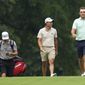 Scottie Scheffler, right, and Collin Morikawa, second from right, walk to their balls on the 14th fairway during a practice round for the PGA TOUR Championship at East Lake Golf Club Wednesday Aug 24, 2022, in Atlanta, Ga. (AP Photo/Steve Helber)