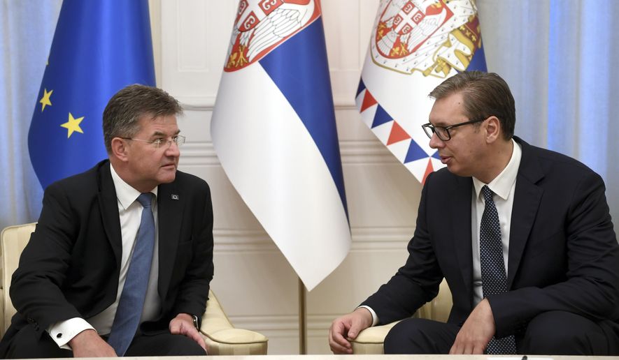 In this photo provided by the Serbian Presidential Press Service, Serbian President Aleksandar Vucic, right, speaks with European Union envoy Miroslav Lajcak in Belgrade, Serbia, Thursday, Aug. 25, 2022. Tensions between Serbia and Kosovo soared anew late last month when Kosovo&#x27;s government declared that Serb-issued identity documents and vehicle license plates would no longer be valid in Kosovo&#x27;s territory, as Kosovo-issued ones are not valid in Serbia. (Serbian Presidential Press Service via AP)