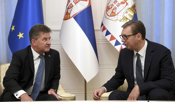 In this photo provided by the Serbian Presidential Press Service, Serbian President Aleksandar Vucic, right, speaks with European Union envoy Miroslav Lajcak in Belgrade, Serbia, Thursday, Aug. 25, 2022. Tensions between Serbia and Kosovo soared anew late last month when Kosovo&#39;s government declared that Serb-issued identity documents and vehicle license plates would no longer be valid in Kosovo&#39;s territory, as Kosovo-issued ones are not valid in Serbia. (Serbian Presidential Press Service via AP)