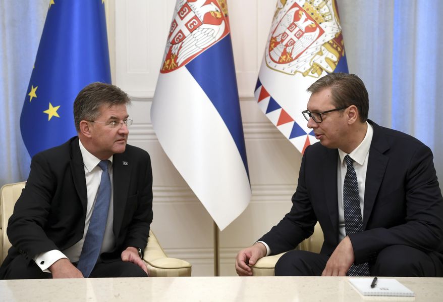In this photo provided by the Serbian Presidential Press Service, Serbian President Aleksandar Vucic, right, speaks with European Union envoy Miroslav Lajcak in Belgrade, Serbia, Thursday, Aug. 25, 2022. Tensions between Serbia and Kosovo soared anew late last month when Kosovo&#x27;s government declared that Serb-issued identity documents and vehicle license plates would no longer be valid in Kosovo&#x27;s territory, as Kosovo-issued ones are not valid in Serbia. (Serbian Presidential Press Service via AP)