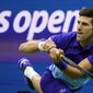 Novak Djokovic, of Serbia, returns a shot to Alexander Zverev, of Germany, during the semifinals of the U.S. Open tennis championships, Friday, Sept. 10, 2021, in New York. Djokovic will not play in the U.S. Open, as expected, because he is not vaccinated against COVID-19 and thus is not allowed to travel to the United States. Djokovic announced his withdrawal from the year’s last Grand Slam tournament on Twitter on Thursday, Aug. 25, 2022, hours before the draw for the event was revealed.  (AP Photo/John Minchillo, File)