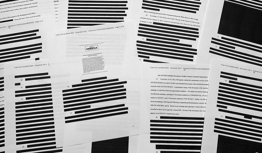 Pages from the affidavit by the FBI in support of obtaining a search warrant for former President Donald Trump&#39;s Mar-a-Lago estate are photographed Friday, Aug. 26, 2022. U.S. Magistrate Judge Bruce Reinhart ordered the Justice Department to make public a redacted version of the affidavit it relied on when federal agents searched Trump&#39;s estate to look for classified documents. (AP Photo/Jon Elswick)
