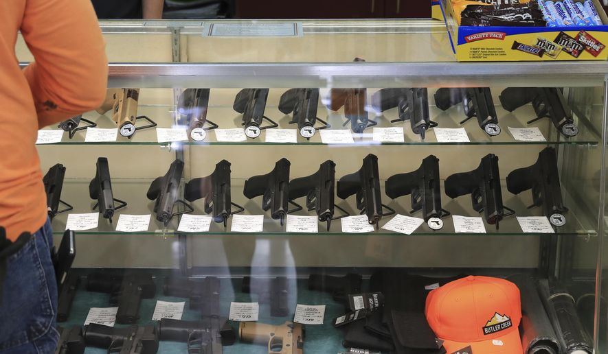 Handguns are on displayed at a gun shop, Thursday, June, 23, 2022 in Honolulu. In Hawaii it&#x27;s traditionally been practically impossible to obtain police permission to carry a loaded gun in public and so far that hasn&#x27;t changed even after a U.S. Supreme Court ruling making it easier to get such permits. Since the decision in June, only one permit has been granted. (AP Photo/Marco Garcia, File)