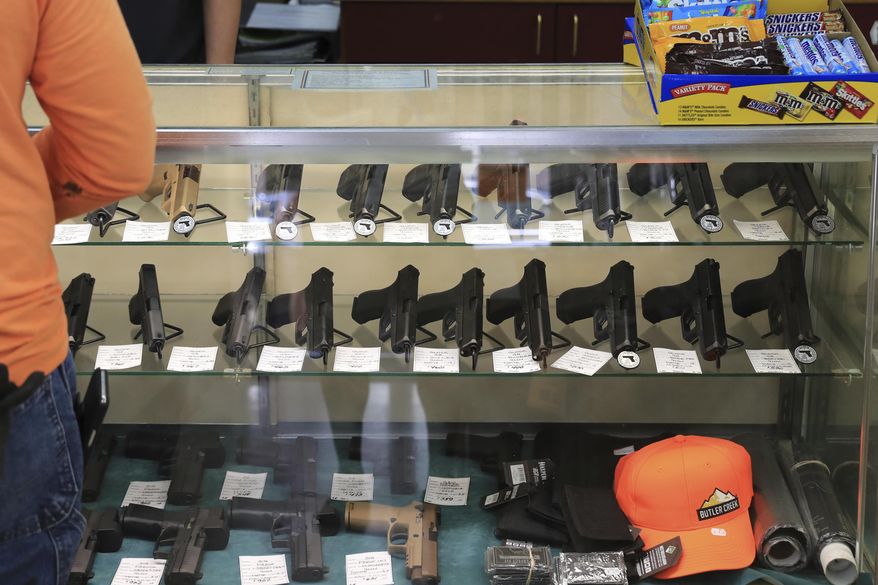 Handguns are on displayed at a gun shop, Thursday, June, 23, 2022 in Honolulu. In Hawaii it&#x27;s traditionally been practically impossible to obtain police permission to carry a loaded gun in public and so far that hasn&#x27;t changed even after a U.S. Supreme Court ruling making it easier to get such permits. Since the decision in June, only one permit has been granted. (AP Photo/Marco Garcia, File)