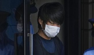 Tetsuya Yamagami, the alleged assassin of former Japanese Prime Minister Shinzo Abe, gets out of a police station in Nara, western Japan, on July 10, 2022, on his way to local prosecutors&#39; office. A glimpse of Yamagami&#39;s painful childhood has led to a surprising amount of sympathy in Japan, where three decades of economic malaise and social disparity have left many feeling isolated and unease. (Nobuki Ito/Kyodo News via AP, File)