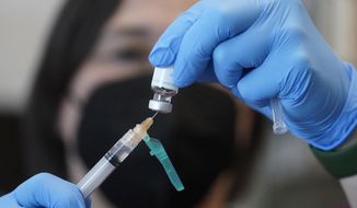 In this file photo, a registered nurse prepares a dose of a monkeypox vaccine at the Salt Lake County Health Department in Salt Lake City on July 28, 2022. (AP Photo/Rick Bowmer, File)