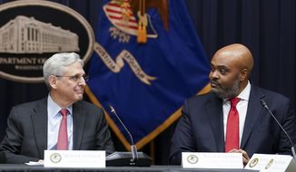 FILE - Attorney General Merrick Garland, looks at federal prosecutor Kevin Chambers, right, after appointing him to be the Justice Department&#39;s chief pandemic fraud prosecutor, during a meeting of the coronavirus disease (COVID-19) Fraud Enforcement Task Force at the Justice Department, March 10, 2022 in Washington. The U.S. Secret Service recovered $286 million in fraudulently obtained pandemic funds to the Small Business Administration, Friday, Aug. 26. (Kevin Lamarque/Pool Photo via AP, File)