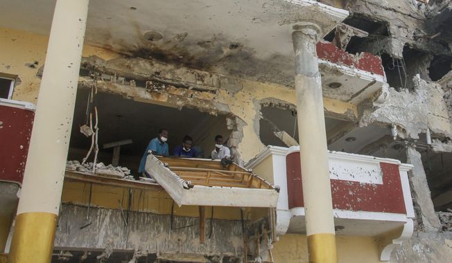 People remove damaged furniture from the destroyed Hayat Hotel, days after a deadly siege by al-Shabab extremists, in Mogadishu, Somalia Wednesday, Aug. 24, 2022. The siege was the longest such attack in the country&#x27;s history taking more than 30 hours for security forces to subdue the extremists, with more than 20 people killed. (AP Photo/Farah Abdi Warsameh)