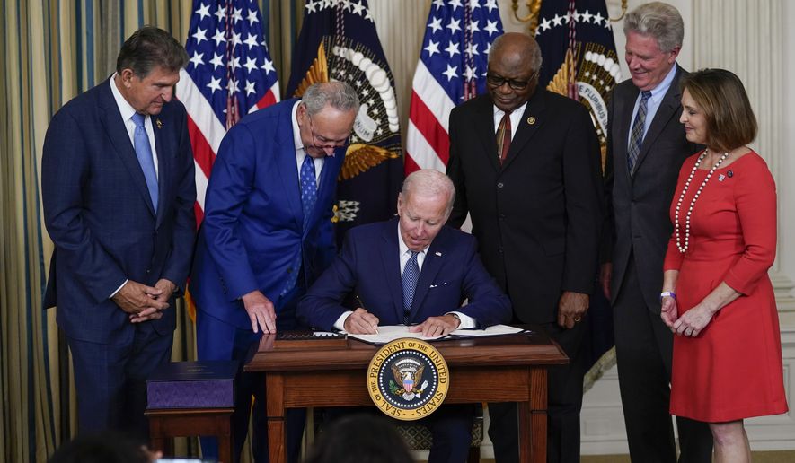 FILE - President Joe Biden signs the Democrats&#39; landmark climate change and health care bill in the State Dining Room of the White House in Washington, Aug. 16, 2022, as from left, Sen. Joe Manchin, D-W.Va., Senate Majority Leader Chuck Schumer of N.Y., House Majority Whip Rep. James Clyburn, D-S.C., Rep. Frank Pallone, D-N.J., and Rep. Kathy Castor, D-Fla., watch. After decades of failed attempts, Democrats passed legislation that aims to reign in the soaring costs of drugs for some Americans. (AP Photo/Susan Walsh, File)