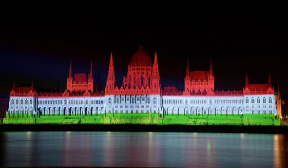 The colors of the Hungarian flag illuminate the Parliament building to mark the national holiday celebrating Hungary&#x27;s statehood in Budapest, Hungary, Saturday, Aug. 20, 2022. State founder St. Stephen I, the first king of Hungary was crowned in 1000 A.D. (Peter Lakatos/MTI via AP)