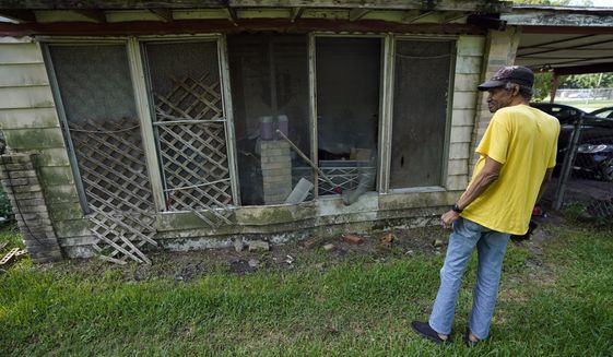 Mal Moses looks over some of the remaining damage to his home from Hurricane Harvey in 2017, Thursday, Aug. 25, 2022, in Houston. A local nonprofit, West Street Recovery, ultimately helped repair his home. (AP Photo/David J. Phillip)